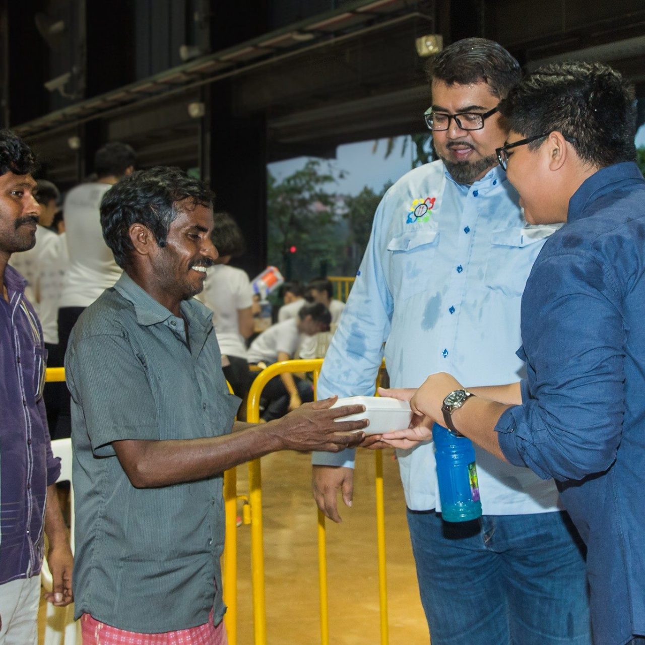Rice-Media-NVPC-Soup-Kitchen-10 Nizar, second from right, helping to distribute food to foreign workers.